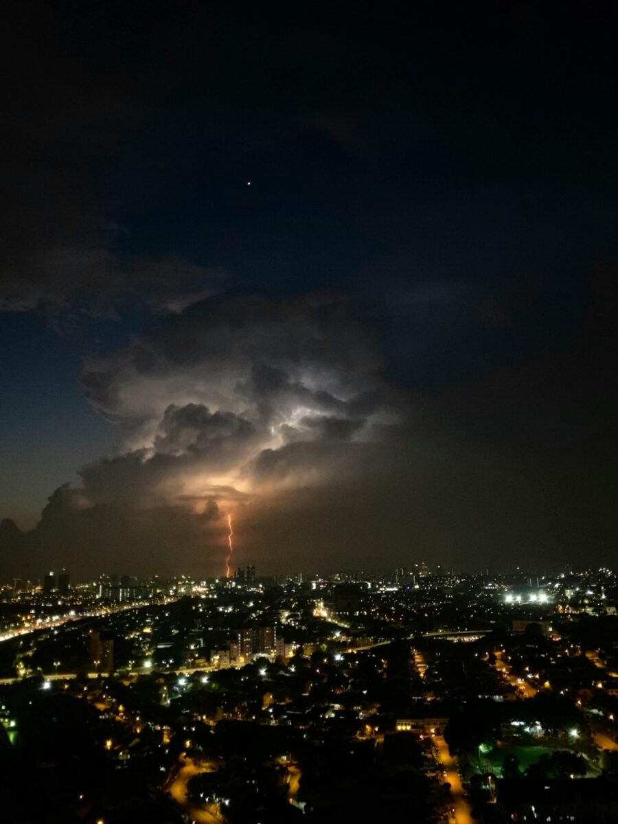 A vivid lightning strike over Kuala Lumpur cityscape during a dramatic night storm.